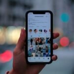 Instagram analytics dashboard showing story reach, impressions, and viewer metrics on a laptop screen