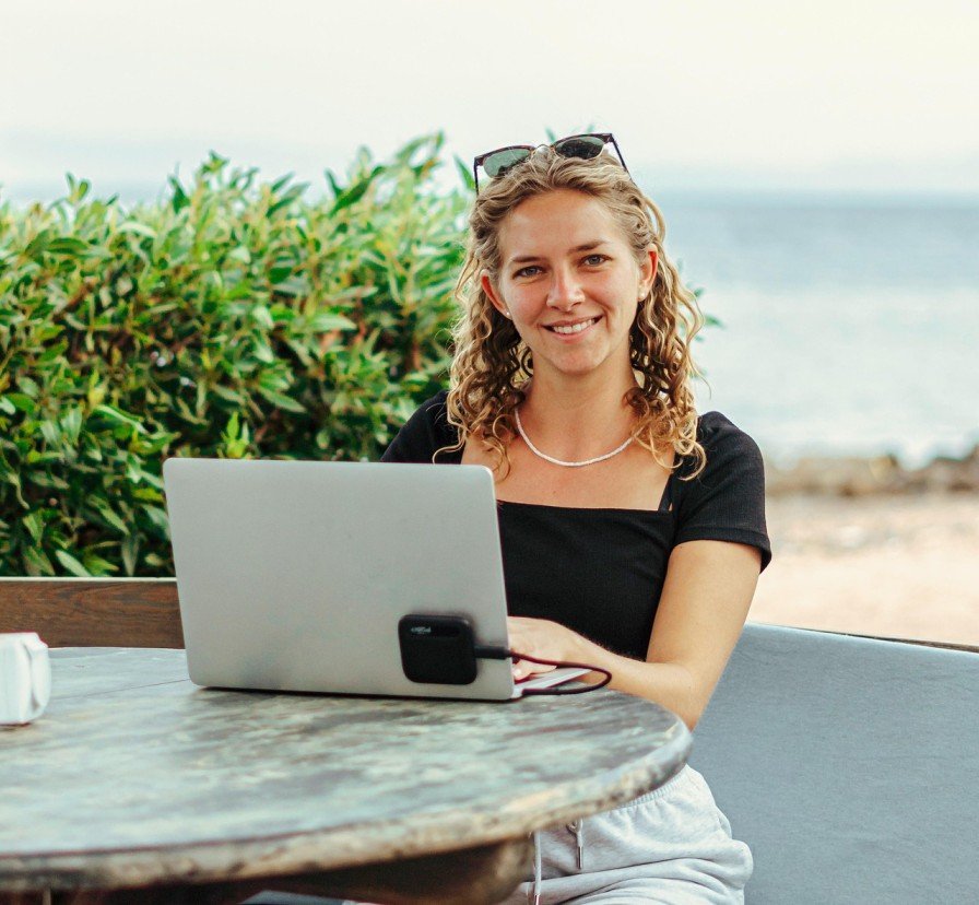 Digital nomad working on laptop with Tamarindo beach sunset Costa Rica 2026